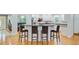Open kitchen featuring bar seating, stainless appliances, granite counters, and hardwood floors at 142 Maxwell Rd, Summerville, SC 29483