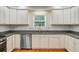 Bright kitchen with white cabinets, stainless steel appliances, granite countertops, and hardwood floors at 142 Maxwell Rd, Summerville, SC 29483