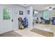 A tiled mudroom features a convenient shoe rack and access to an office space with a large-screen TV at 142 Maxwell Rd, Summerville, SC 29483
