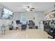 Bright office space featuring multiple workstations, a ceiling fan, and a large-screen TV for an inviting workspace at 142 Maxwell Rd, Summerville, SC 29483