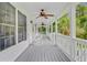 Relaxing covered porch featuring rocking chairs, ceiling fans, and a peaceful outdoor setting at 142 Maxwell Rd, Summerville, SC 29483
