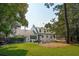 Expansive backyard featuring lush lawn, mature trees, and an inviting patio area at 1446 Burningtree Rd, Charleston, SC 29412