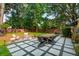 Inviting backyard patio with modern pavers, stylish seating, and a cozy fire pit at 1446 Burningtree Rd, Charleston, SC 29412