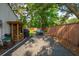 Spacious backyard with a ping pong table, woodpile, and lush green trees, perfect for outdoor activities and relaxation at 1446 Burningtree Rd, Charleston, SC 29412