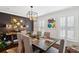 Elegant dining room with a modern chandelier, dark accent wall, and seating for six at 1446 Burningtree Rd, Charleston, SC 29412