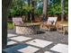 Backyard fire pit with stone pavers and seating area, ideal for outdoor entertaining at 1446 Burningtree Rd, Charleston, SC 29412