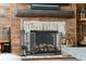 Living room fireplace with rustic wood mantel and brick accents, creating a cozy ambiance at 1446 Burningtree Rd, Charleston, SC 29412