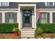 Inviting front door with dark trim, decorative windows, and a charming brick paver landing at 1446 Burningtree Rd, Charleston, SC 29412