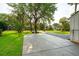 Long driveway leads to a well-manicured lawn and home with lush, mature trees and basketball hoop at 1446 Burningtree Rd, Charleston, SC 29412