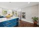 Well-lit kitchen featuring white brick accent wall, stainless steel appliances, and dark hardwood floors at 1446 Burningtree Rd, Charleston, SC 29412