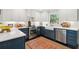 Stylish kitchen with stainless steel appliances, a farmhouse sink, and modern blue and white cabinets at 1446 Burningtree Rd, Charleston, SC 29412