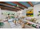 Bright living room featuring wood beam ceiling, white walls, large windows, and comfortable seating at 1446 Burningtree Rd, Charleston, SC 29412