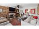 Stylish living room featuring a wood-paneled wall with fireplace, TV, and rustic decor at 1446 Burningtree Rd, Charleston, SC 29412