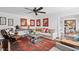 Comfortable living room featuring a ceiling fan, modern furniture, and artistic wall decor at 1446 Burningtree Rd, Charleston, SC 29412