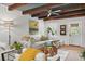 Cozy living room featuring a white couch, wood beams, large windows, and a comfortable seating area at 1446 Burningtree Rd, Charleston, SC 29412