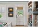 Bright living room with a view to the exterior featuring white door, window, and bookcase at 1446 Burningtree Rd, Charleston, SC 29412