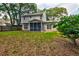 Large backyard featuring a spacious screened in porch and mature landscaping at 1552 Harborsun Dr, Charleston, SC 29412