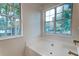 Bright bathroom featuring a soaking tub and two windows providing plenty of natural light at 1552 Harborsun Dr, Charleston, SC 29412