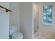 Bathroom with a toilet and a marble tiled shower plus a window at 1552 Harborsun Dr, Charleston, SC 29412
