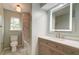 The updated bathroom features a vanity with an illuminated mirror and a separate tub and toilet at 1552 Harborsun Dr, Charleston, SC 29412