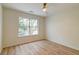 Bedroom featuring wood-look floors, ceiling fan and large window with wooded views at 1552 Harborsun Dr, Charleston, SC 29412