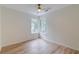 Bedroom featuring wood-look floors, a ceiling fan, and two large windows with wooded views at 1552 Harborsun Dr, Charleston, SC 29412