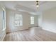 Bright primary bedroom featuring hardwood floors, a ceiling fan, large windows, and neutral decor at 1552 Harborsun Dr, Charleston, SC 29412