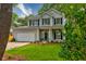 Charming two-story home with a well-manicured lawn and black shutters for a classic look at 1552 Harborsun Dr, Charleston, SC 29412