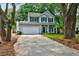 Traditional two-story home with a two-car garage and a well-maintained front lawn at 1552 Harborsun Dr, Charleston, SC 29412
