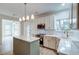 Bright kitchen featuring white cabinets, a stylish island with a stone countertop, and stainless steel appliances at 1552 Harborsun Dr, Charleston, SC 29412