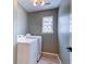 Bright laundry room with a window and modern appliances, washer and dryer ready for use at 1552 Harborsun Dr, Charleston, SC 29412