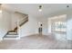 Bright living room featuring modern flooring, a staircase, and an open floor plan at 1552 Harborsun Dr, Charleston, SC 29412