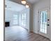Bright living room with a fireplace, large windows, hardwood floors, and neutral decor at 1552 Harborsun Dr, Charleston, SC 29412