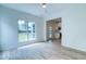 Bright living room with large windows, wood floors, view to kitchen, and neutral decor at 1552 Harborsun Dr, Charleston, SC 29412