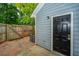 Cozy backyard featuring a modern light fixture, exterior door, and wooden fence at 1686 Hunters Run Dr, Mount Pleasant, SC 29464