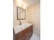 Bathroom vanity with a wood cabinet and drawers, white counter top, undermount sink and frameless mirror at 1686 Hunters Run Dr, Mount Pleasant, SC 29464