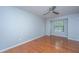 Bedroom with wood floors, a window with blinds, ceiling fan and light blue walls at 1686 Hunters Run Dr, Mount Pleasant, SC 29464