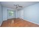 Bedroom with wood floors, neutral walls, a ceiling fan, a window and two doors at 1686 Hunters Run Dr, Mount Pleasant, SC 29464