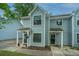 Quaint townhome exteriors with covered entrances and manicured front yards at 1686 Hunters Run Dr, Mount Pleasant, SC 29464