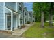 Desirable townhomes showing light blue siding, a small front garden, and tree lined street at 1686 Hunters Run Dr, Mount Pleasant, SC 29464