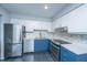 Modern kitchen features stainless steel appliances, blue and white cabinetry, and tile backsplash at 1686 Hunters Run Dr, Mount Pleasant, SC 29464