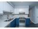 Updated kitchen with stainless steel appliances, white countertops, and stylish tile backsplash at 1686 Hunters Run Dr, Mount Pleasant, SC 29464