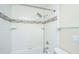 Updated shower features white subway tile with decorative accent and modern shower head and fixtures at 1686 Hunters Run Dr, Mount Pleasant, SC 29464