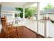 Spacious front porch featuring classic rocking chairs and a wood deck at 1705 Bella Terra Ln, Charleston, SC 29412