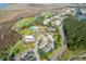 Expansive aerial view of the community with a golf course, pool, tennis courts, and lush greenery at 1800 Palmetto Isle Dr, Mount Pleasant, SC 29466