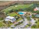 Aerial view showcasing the community clubhouse, pool, tennis courts, and parking area at 1800 Palmetto Isle Dr, Mount Pleasant, SC 29466