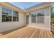 Back deck with large windows and door leading inside, offering a charming extension of the living space at 1800 Palmetto Isle Dr, Mount Pleasant, SC 29466