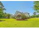 Expansive backyard showcases the home's exterior, lush lawn, and privacy landscaping, perfect for outdoor enjoyment at 1800 Palmetto Isle Dr, Mount Pleasant, SC 29466