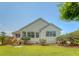 Well-maintained backyard showcasing lush green grass and house with ample windows for natural light at 1800 Palmetto Isle Dr, Mount Pleasant, SC 29466
