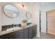 Modern bathroom features a double vanity, round mirrors and decorative lighting at 1800 Palmetto Isle Dr, Mount Pleasant, SC 29466